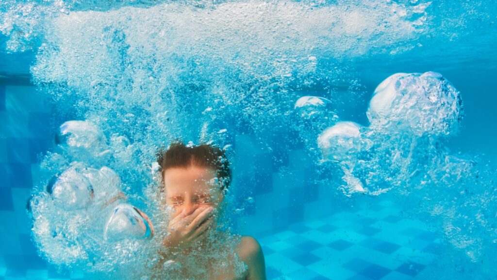 boy diving in swimming pool picture id1144442406